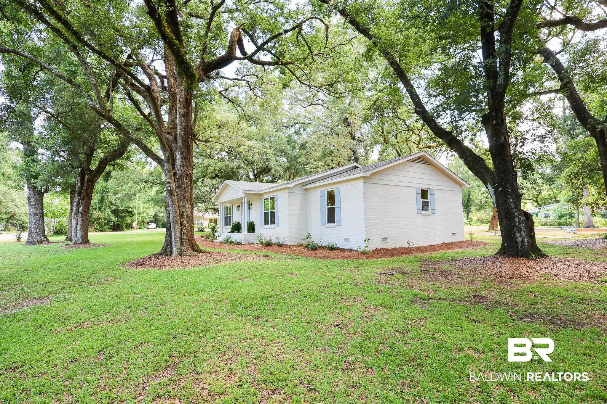12190 Pecan Grove Street Magnolia Springs, AL 36555 - Photo 37 of 45 View of home's exterior with a lawn