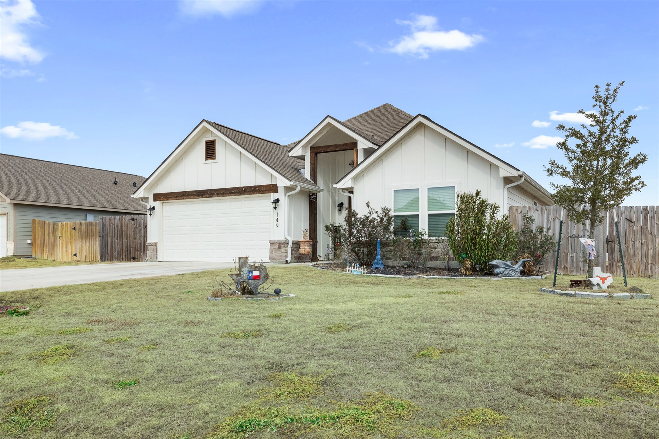 149 Windmill Road Somerville, TX 77879 - Photo 2 of 31 View of front facade with board and batten siding, concrete driveway, and a garage