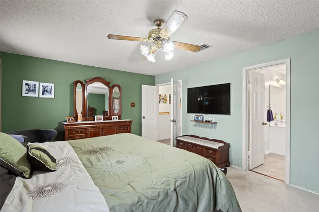 a bedroom with a large bed and a flat screen tv