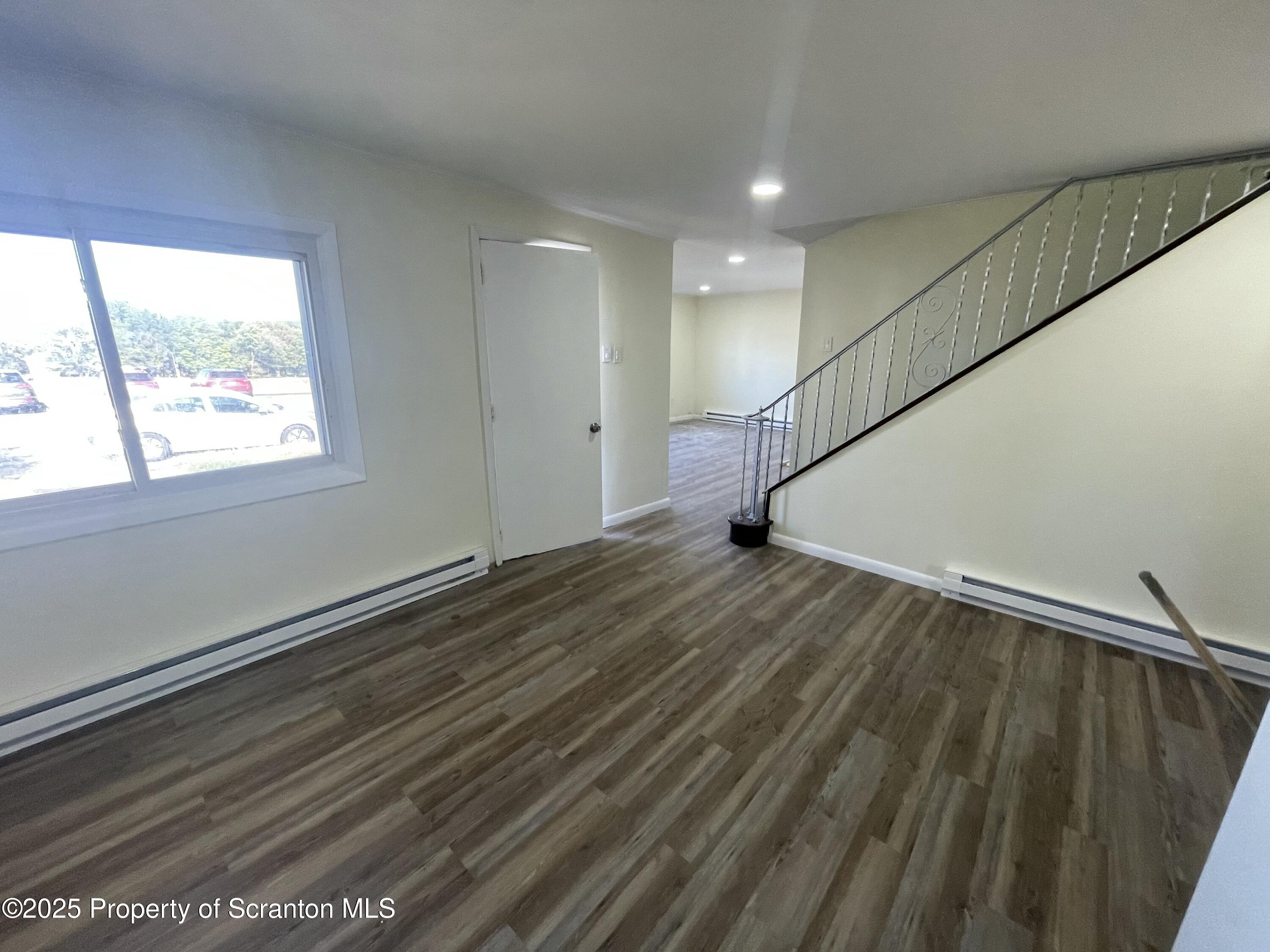 116 Wright Street Duryea, PA 18642 - Photo 4 of 14 a view of an empty room with wooden floor and a window