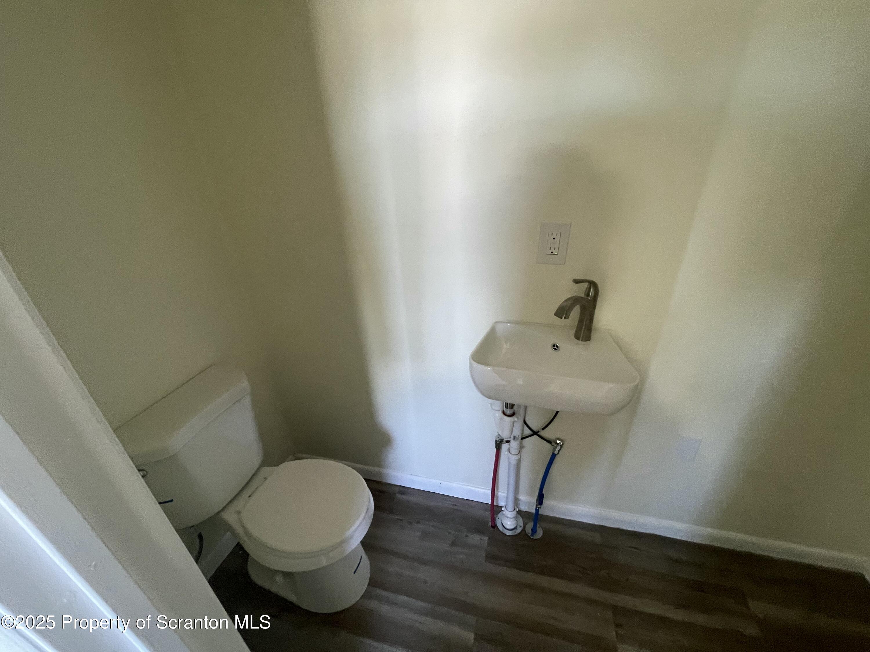 116 Wright Street Duryea, PA 18642 - Photo 8 of 14 a bathroom with a sink a toilet and a mirror