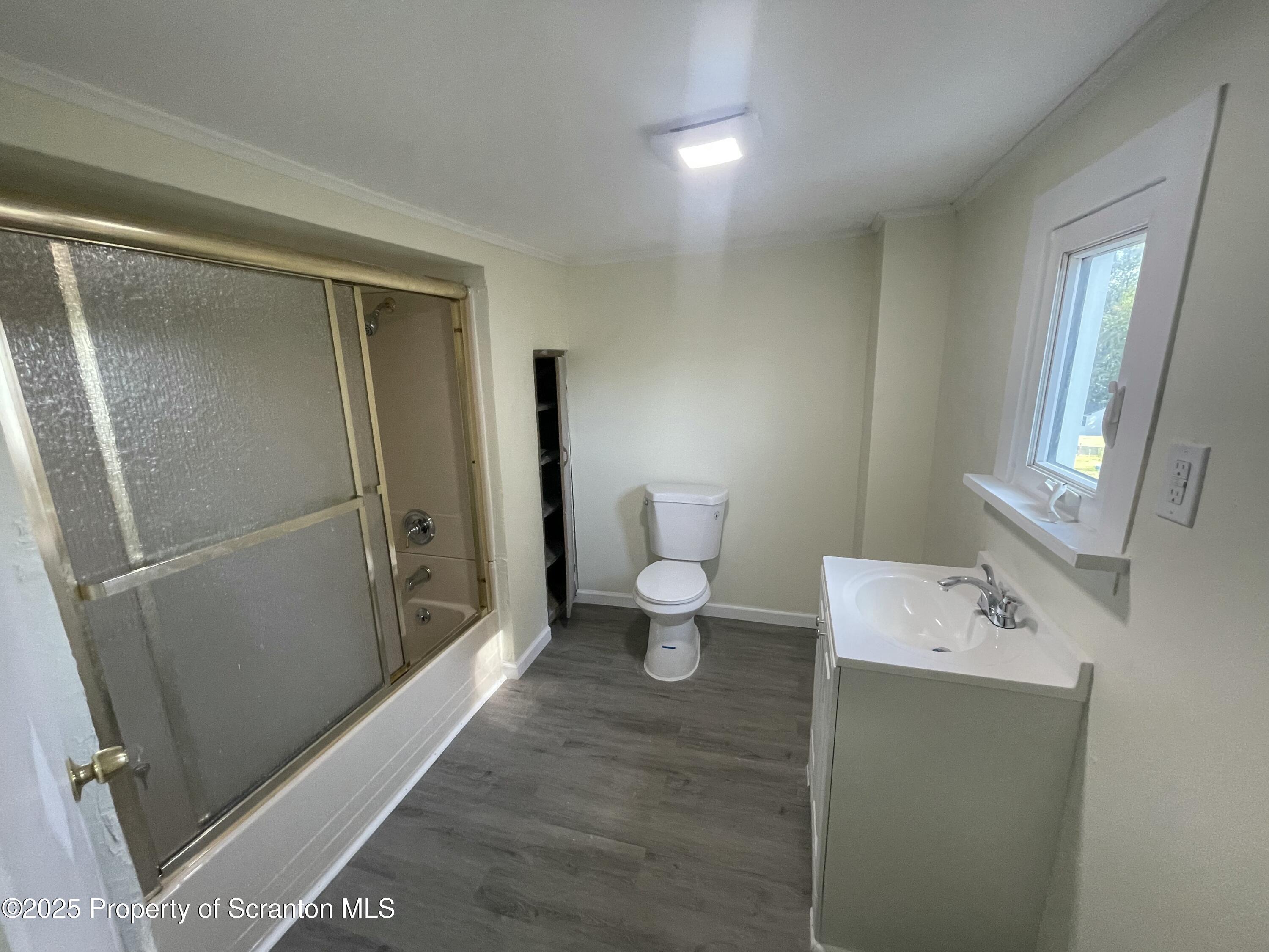 116 Wright Street Duryea, PA 18642 - Photo 9 of 14 a bathroom with a toilet sink and mirror