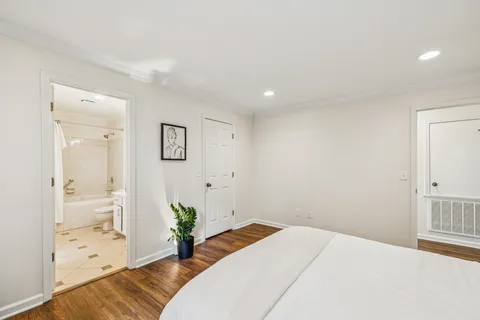 a bedroom with a bed and hallway