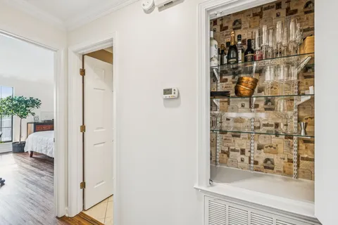 a view of walk in closet with wooden floor