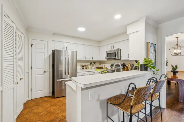 a kitchen with refrigerator cabinets and furniture