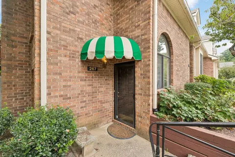 a brick house with a potted plant and a potted plant