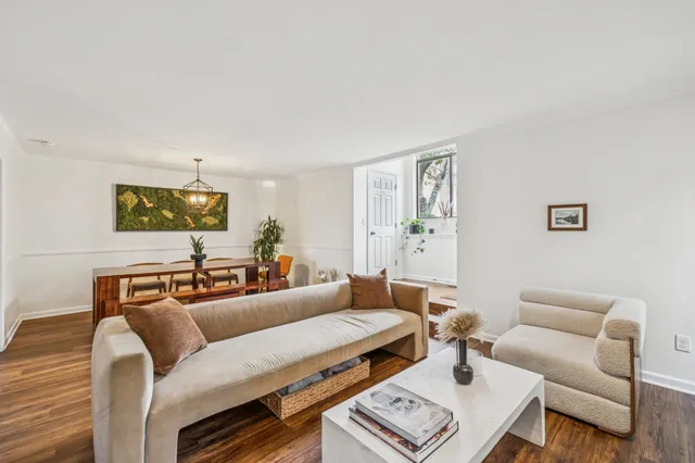 a living room with furniture a rug and a window