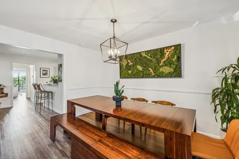 a dining room with furniture window and wooden floor