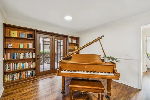 a living room with furniture and a book shelf