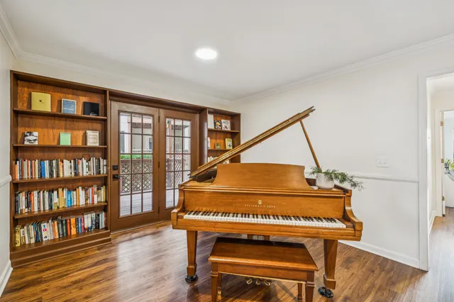 a living room with furniture and a book shelf