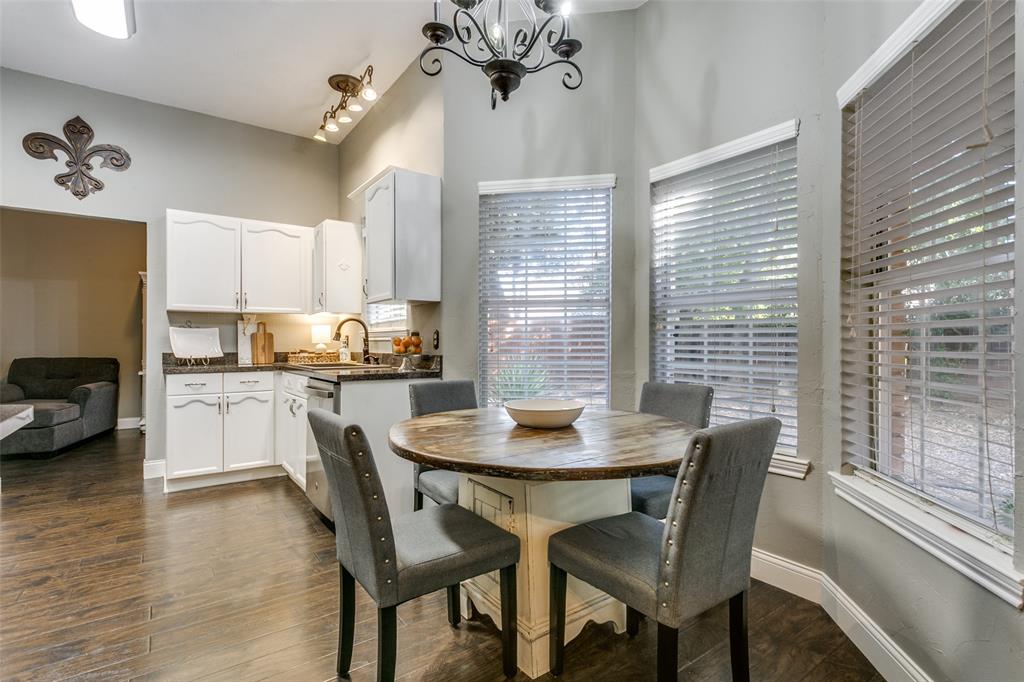 2133 Rim Rock Drive Keller, TX 76248 - Photo 15 of 37 Dining space with dark wood-style flooring, a chandelier, and a towering ceiling