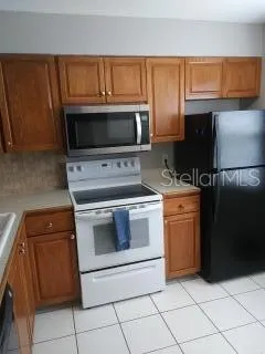 a kitchen with a stove microwave and refrigerator