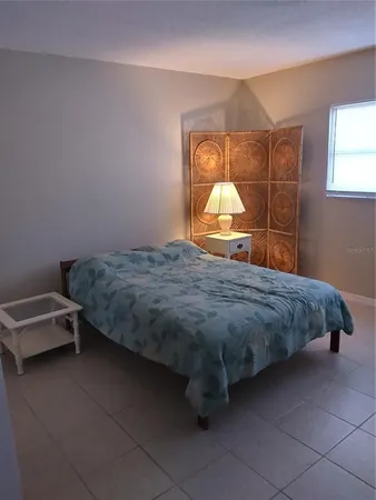 a bedroom with a bed and window