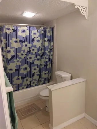 a bathroom with a shower toilet and sink