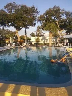 a view of swimming pool and lake from a balcony