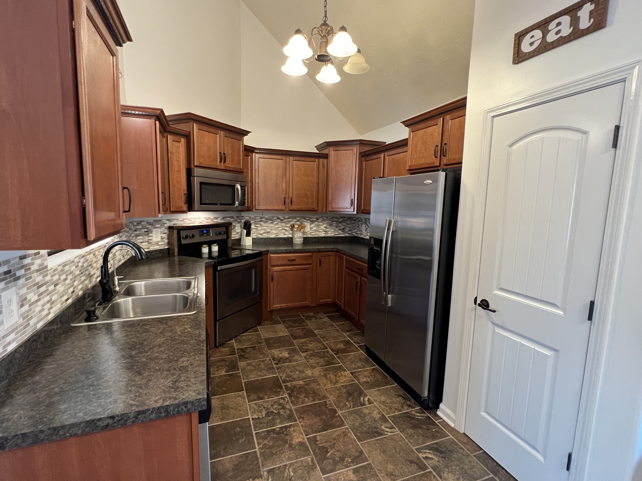 3785 Suiter Road Clarksville, TN 37040 - Photo 8 of 21 a kitchen with stainless steel appliances granite countertop a sink stove and refrigerator