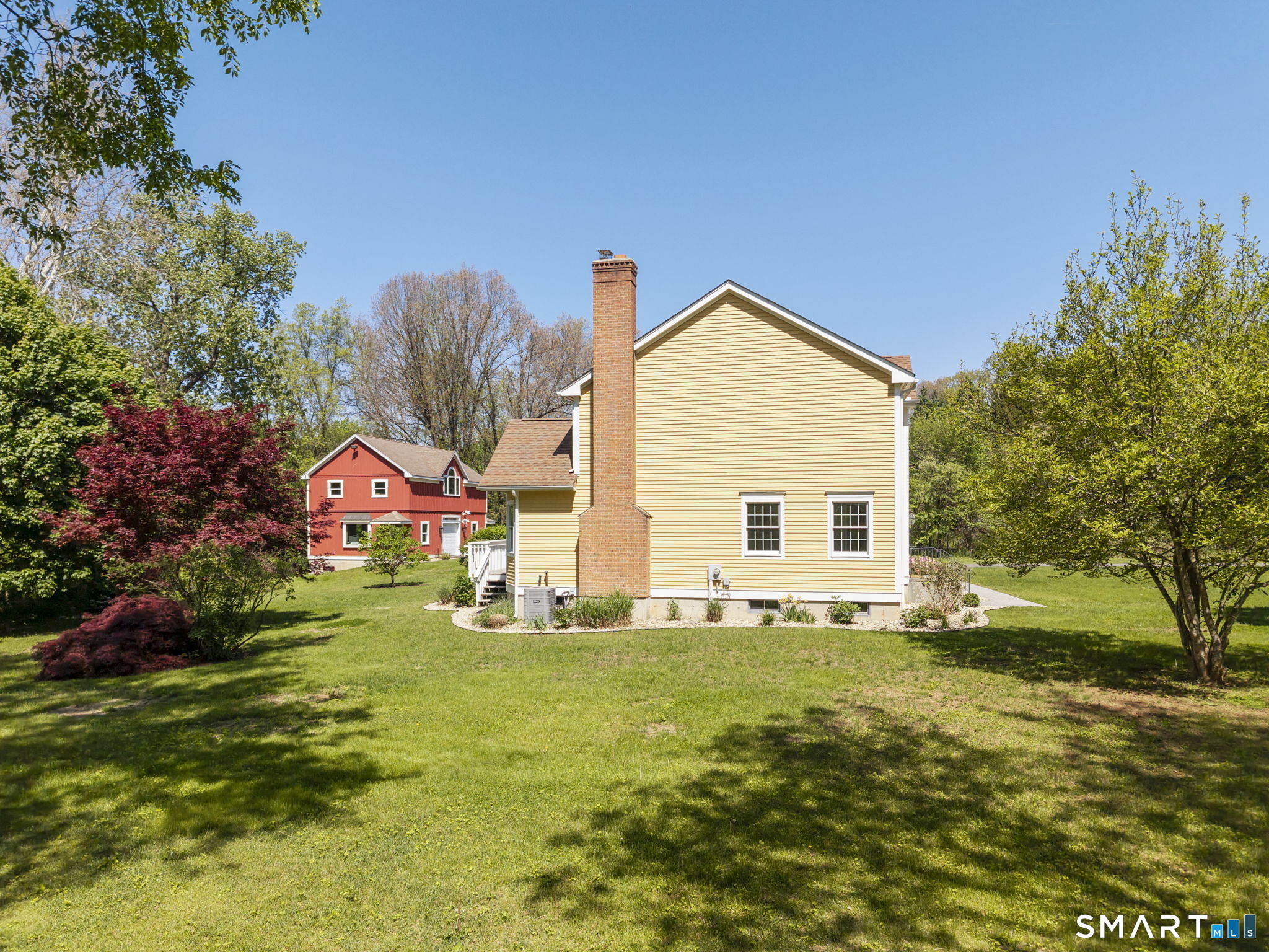 555 Waterville Road Avon, CT 06001 - Photo 4 of 40 a front view of house with yard and trees