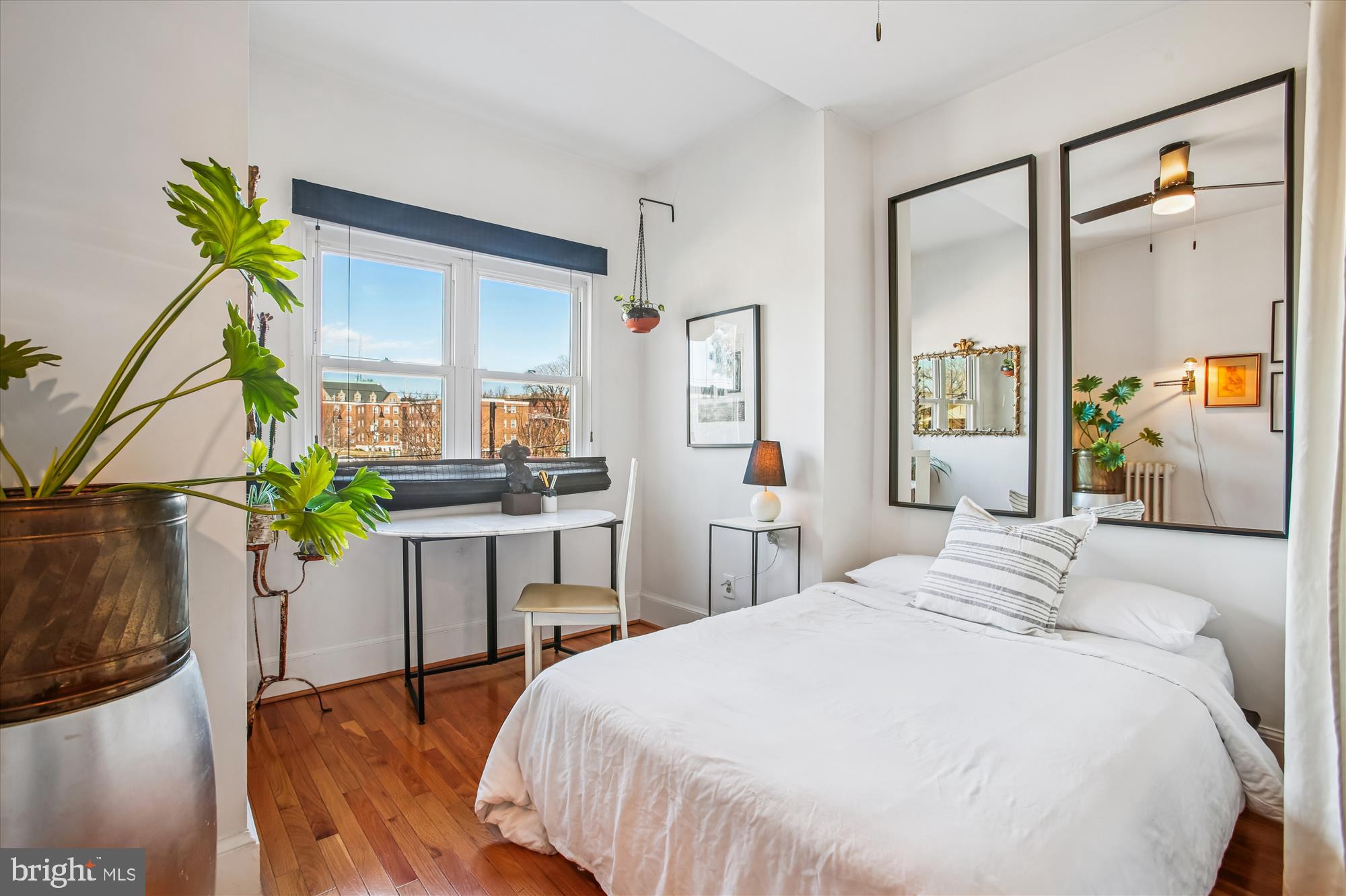 309 Elm Street Northwest Washington, DC 20001 - Photo 60 of 106 a bedroom with a bed table and a painting on the wall