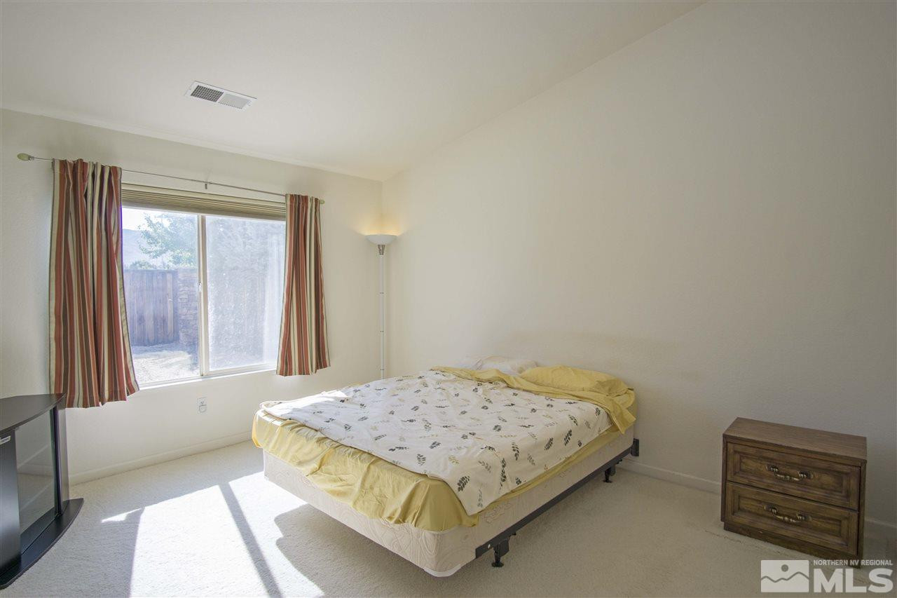 9428 Mammoth Drive Reno, NV 89521 - Photo 9 of 18 a bedroom with a bed and a window