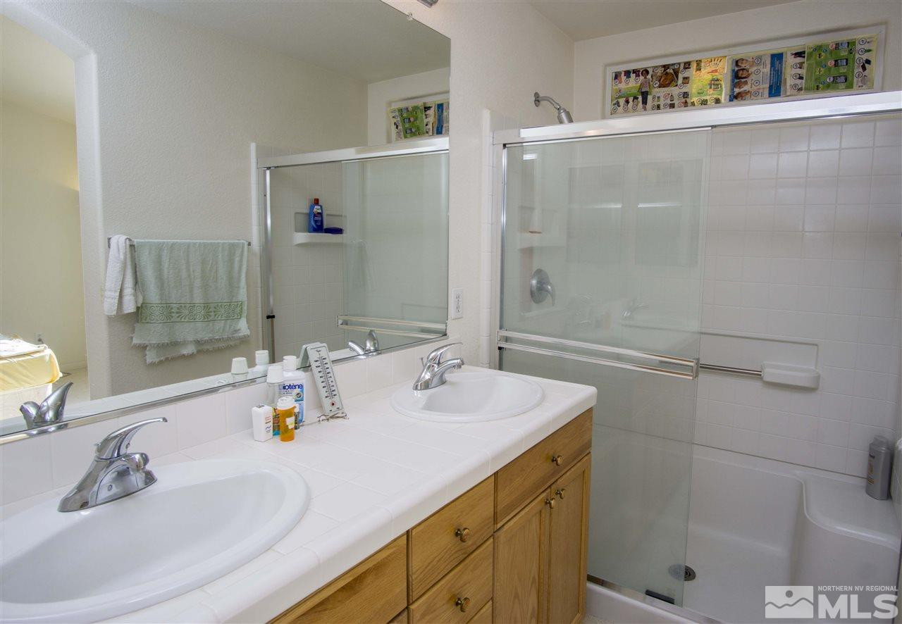 9428 Mammoth Drive Reno, NV 89521 - Photo 10 of 18 a bathroom with a tub sink and mirror