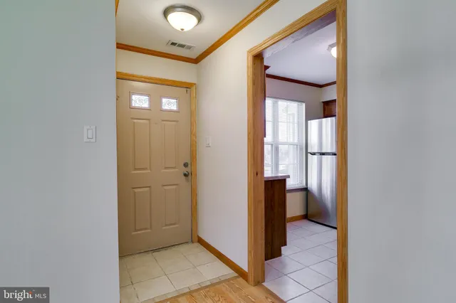 a view of a hallway with bathroom and a bathroom