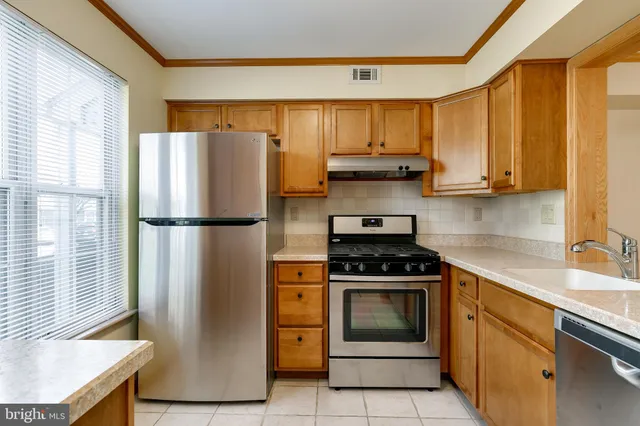 a kitchen with a stove a refrigerator and a sink