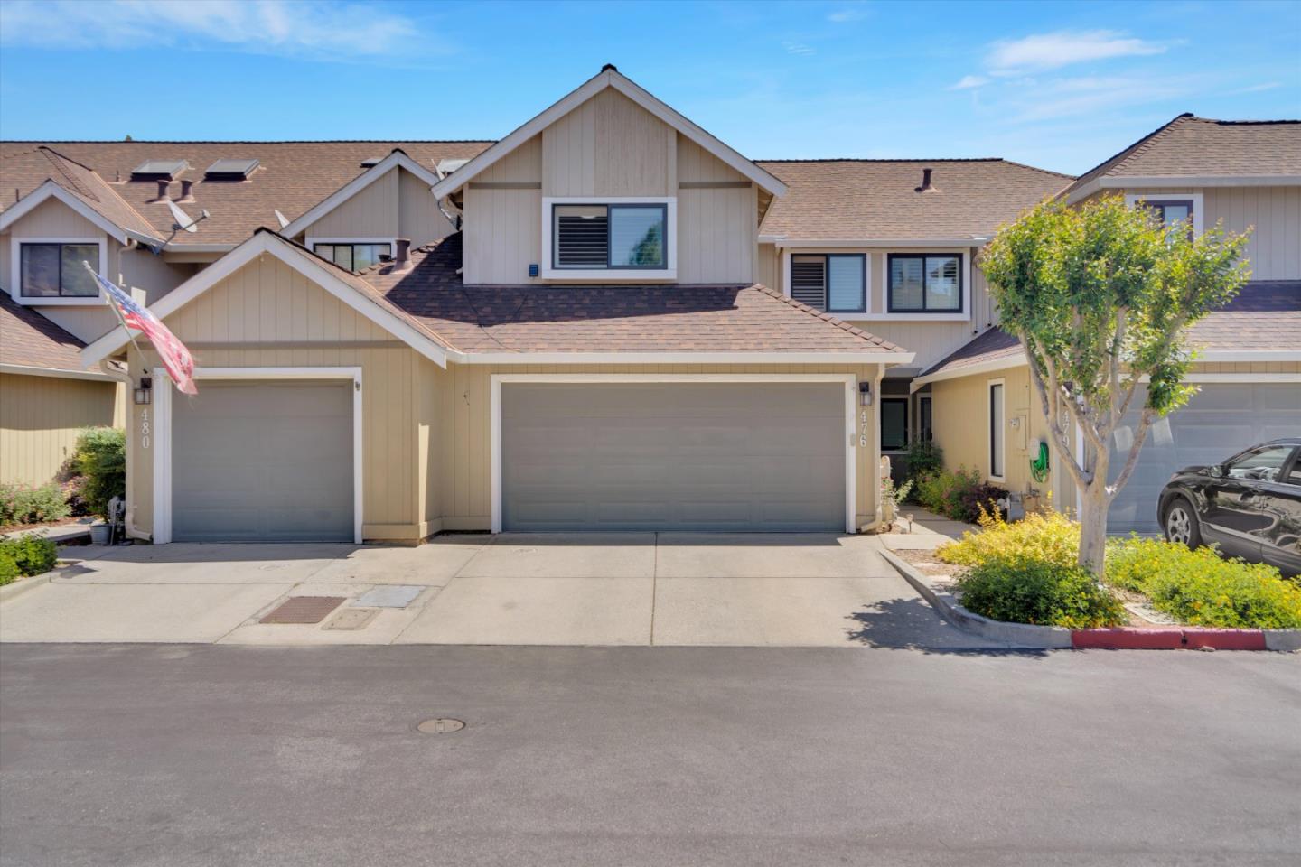 a front view of a house with a yard and garage