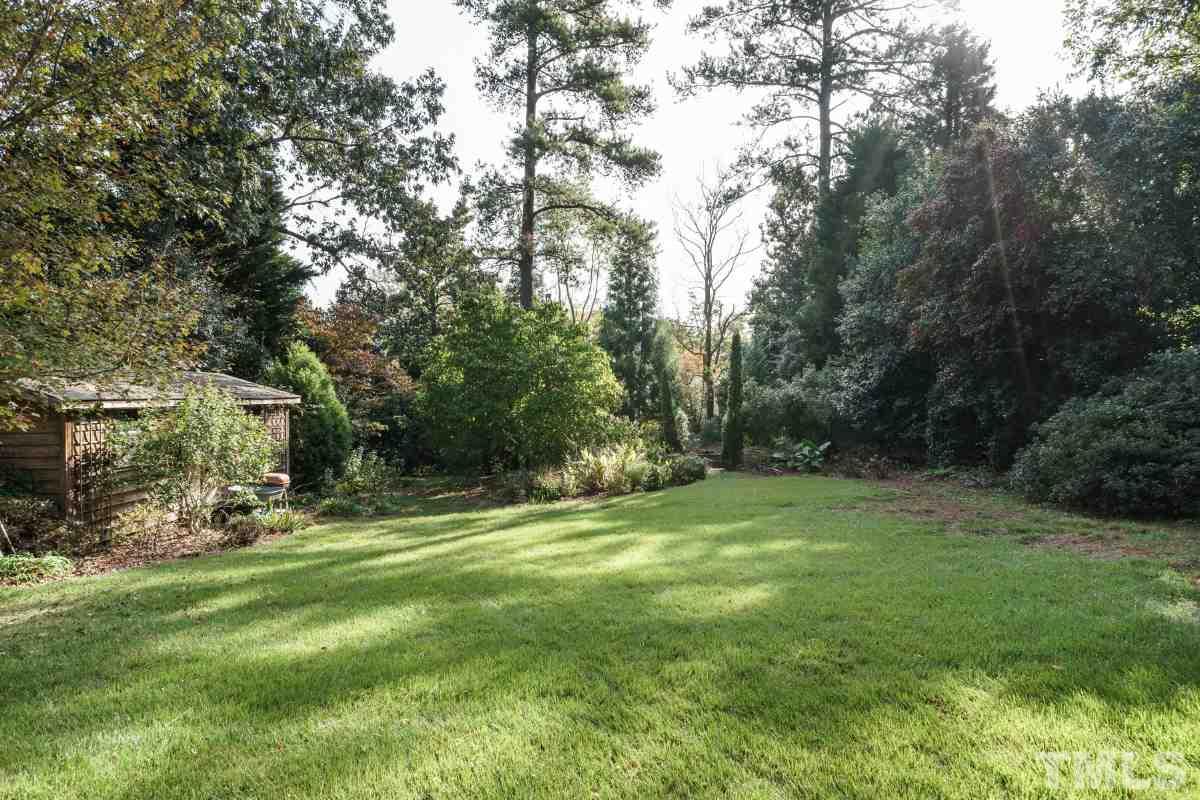 1508 Canterbury Road Raleigh, NC 27608 - Photo 8 of 25 Step outside onto the gently sloping lawn that includes a detached, wired shed that could be a studio, workshop, rec room, whatever.