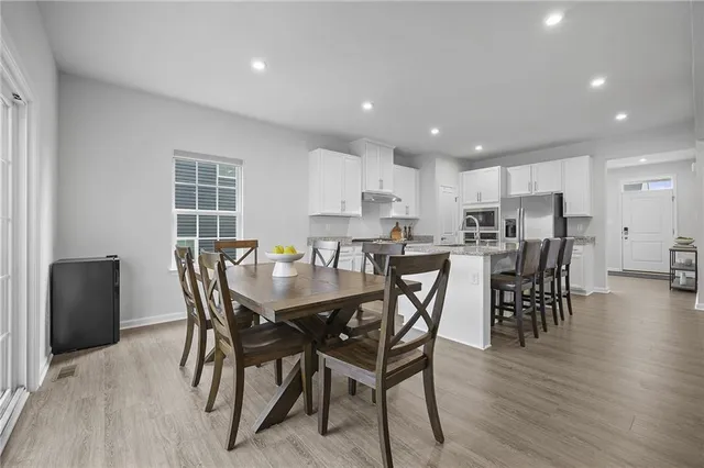 a view of a dining room with furniture and wooden floor
