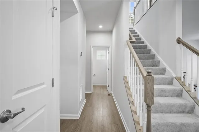 a view of a hallway with wooden floor and entryway