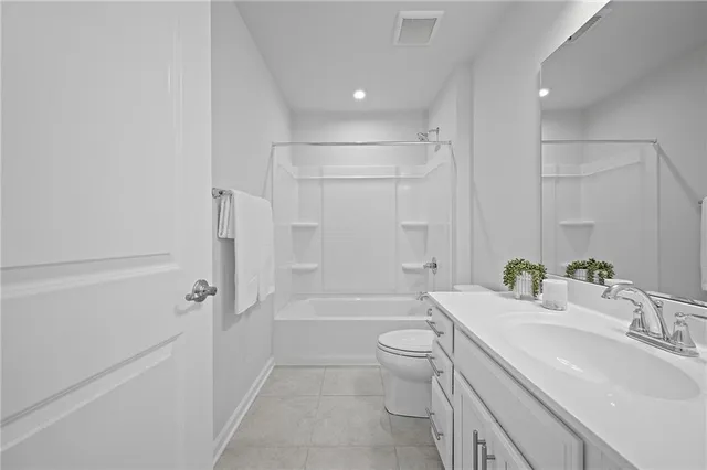 a bathroom with a bathtub shower sink vanity mirror and toilet