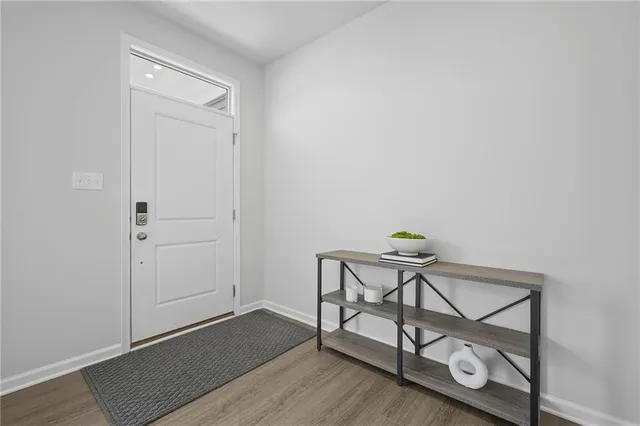 a view of a room with chairs and wooden floor