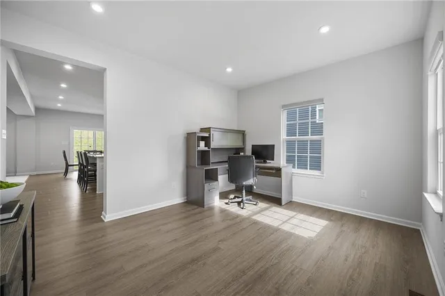 a view of a workspace with furniture and a window