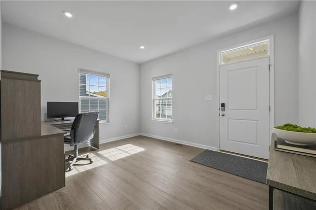 a workspace with wooden floor and a window
