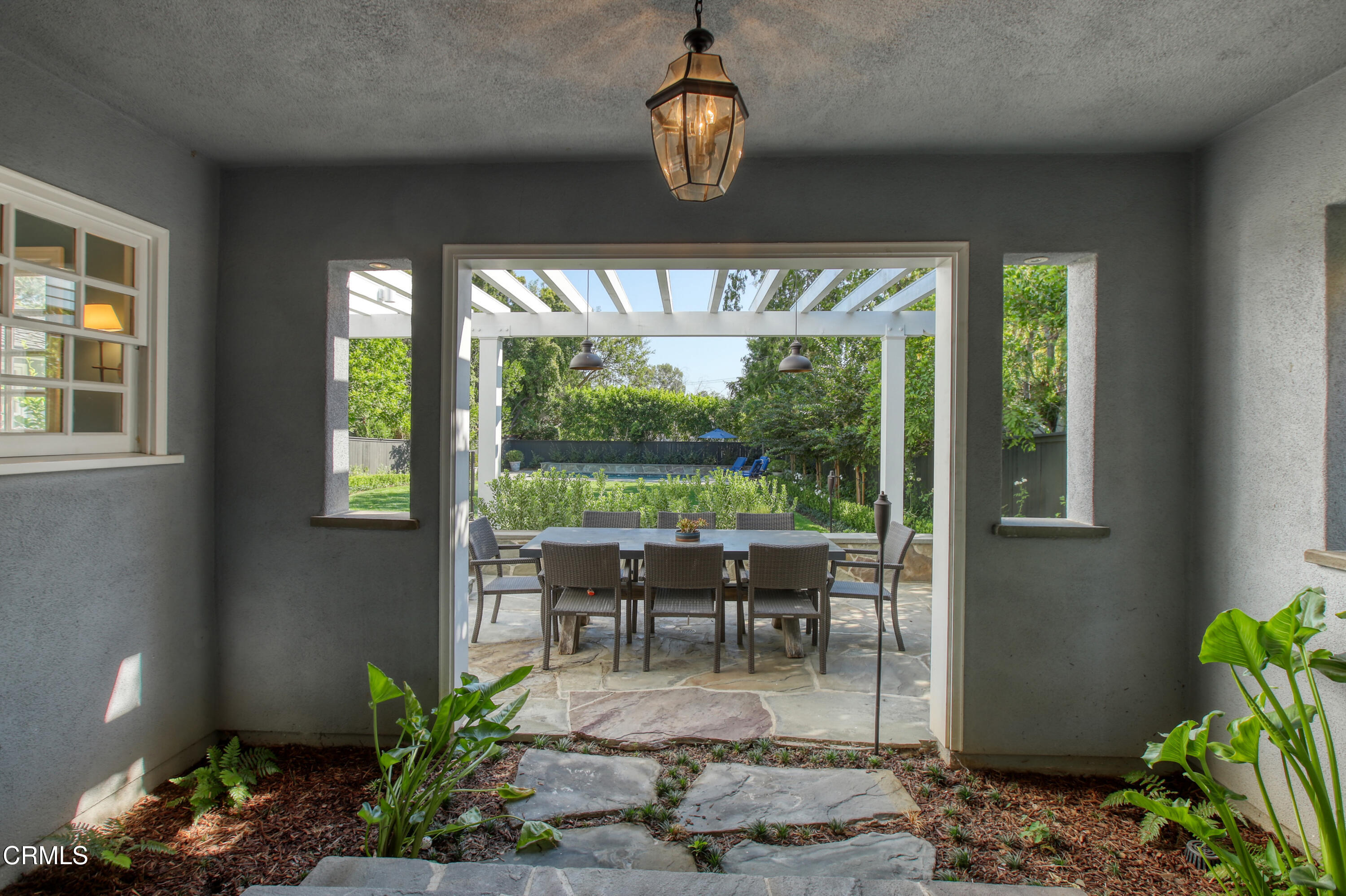 181 Sierra View Road Pasadena, CA 91105 - Photo 34 of 41 a dining room with wooden floor a chandelier a potted plant and windows