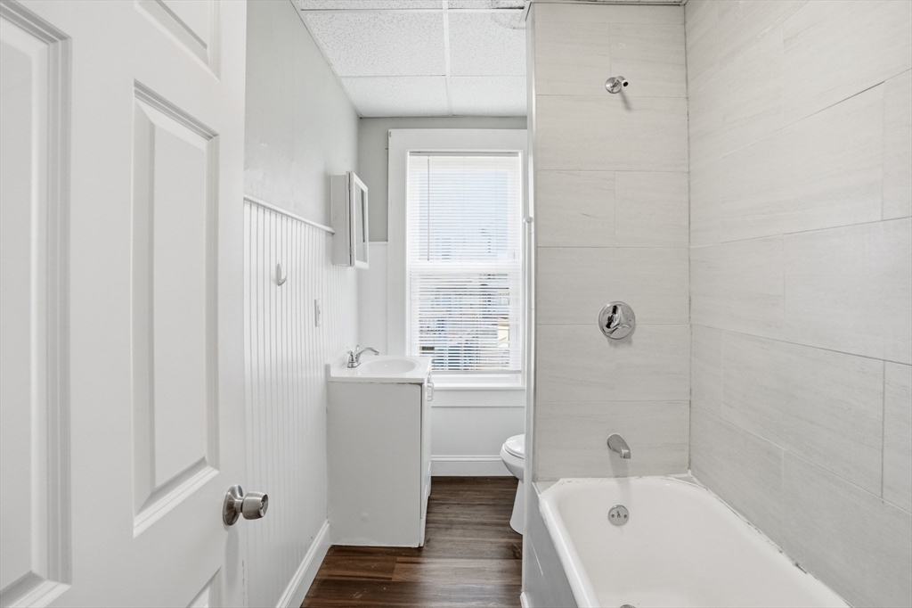 196 Irving Street Fall River, MA 02723 - Photo 7 of 34 a bathroom with a bathtub a toilet and a sink