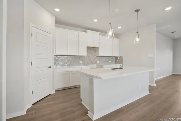 a kitchen with a sink window and cabinets