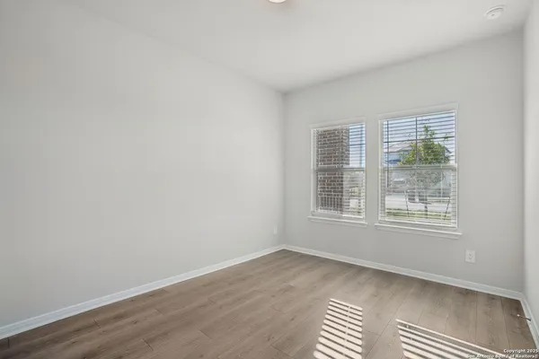 a view of wooden floor and closet in a room