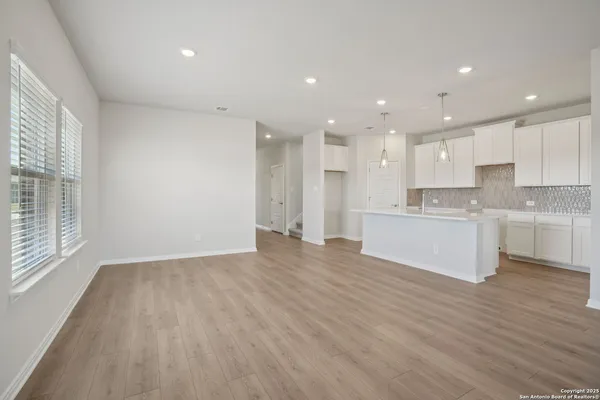a view of kitchen with kitchen island wooden cabinets and stainless steel appliances