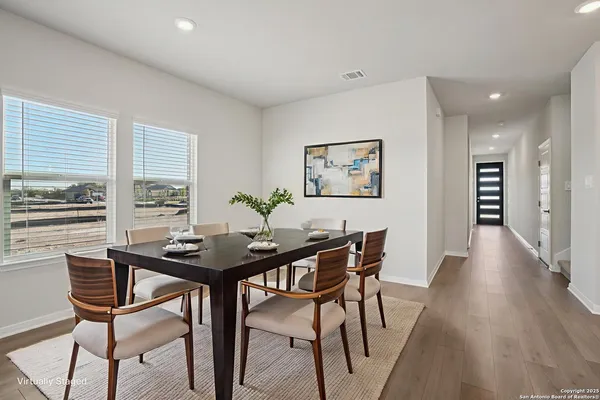 a view of a dining room with furniture and wooden floor