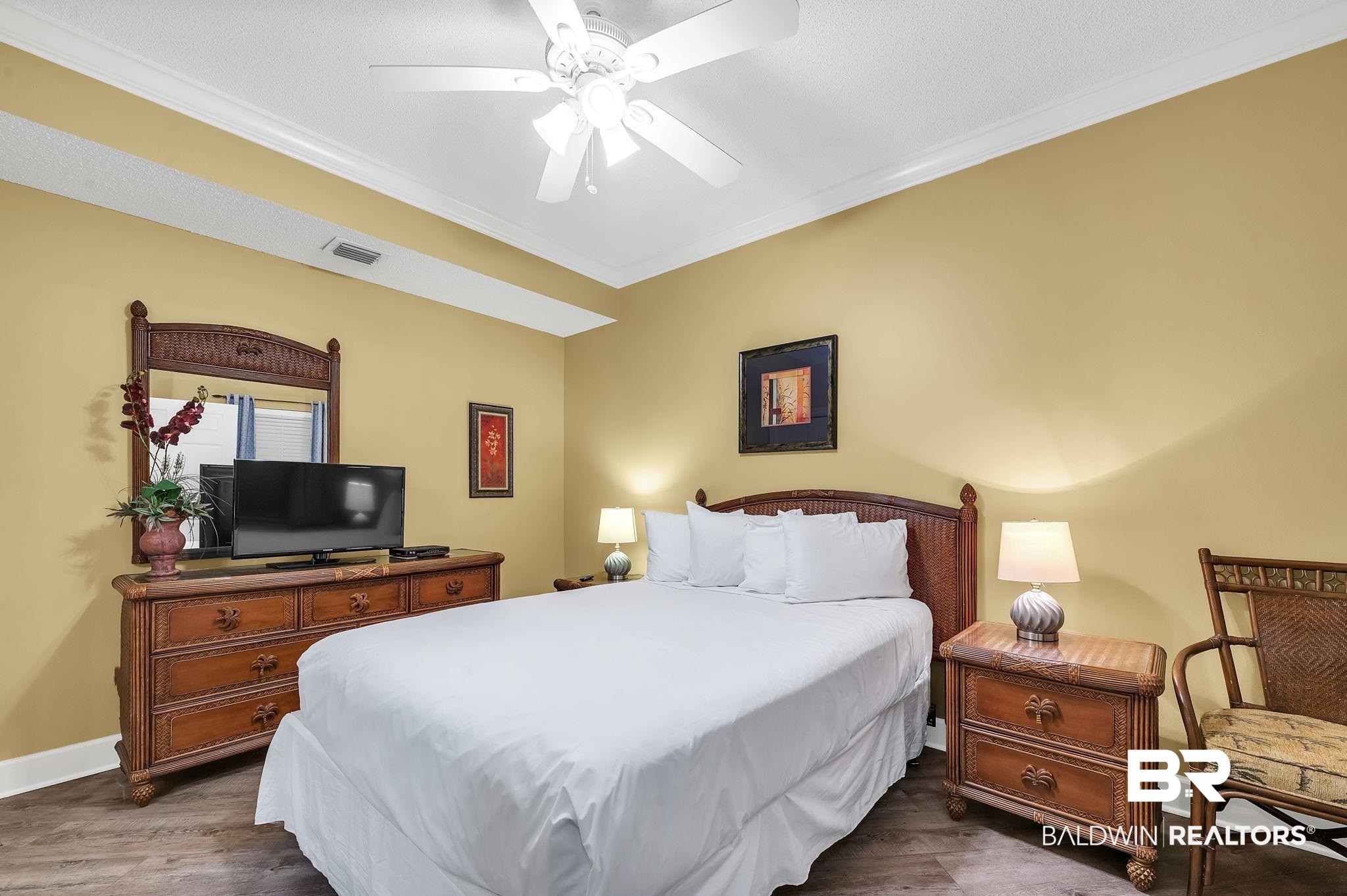 27580 Canal Road, Unit 1214 AND BOAT SLIP #62 Orange Beach, AL 36561 - Photo 33 of 67 Bedroom with visible vents, baseboards, dark wood-style flooring, ornamental molding, and ceiling fan
