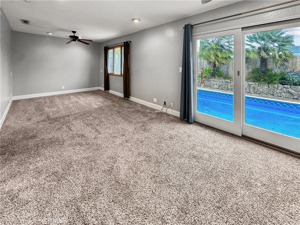 15 Regent Loop Oroville, CA 95966 - Photo 10 of 22 an empty room with sliding door and wooden floor