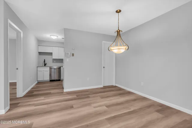 a view of a room with cabinet and wooden floor