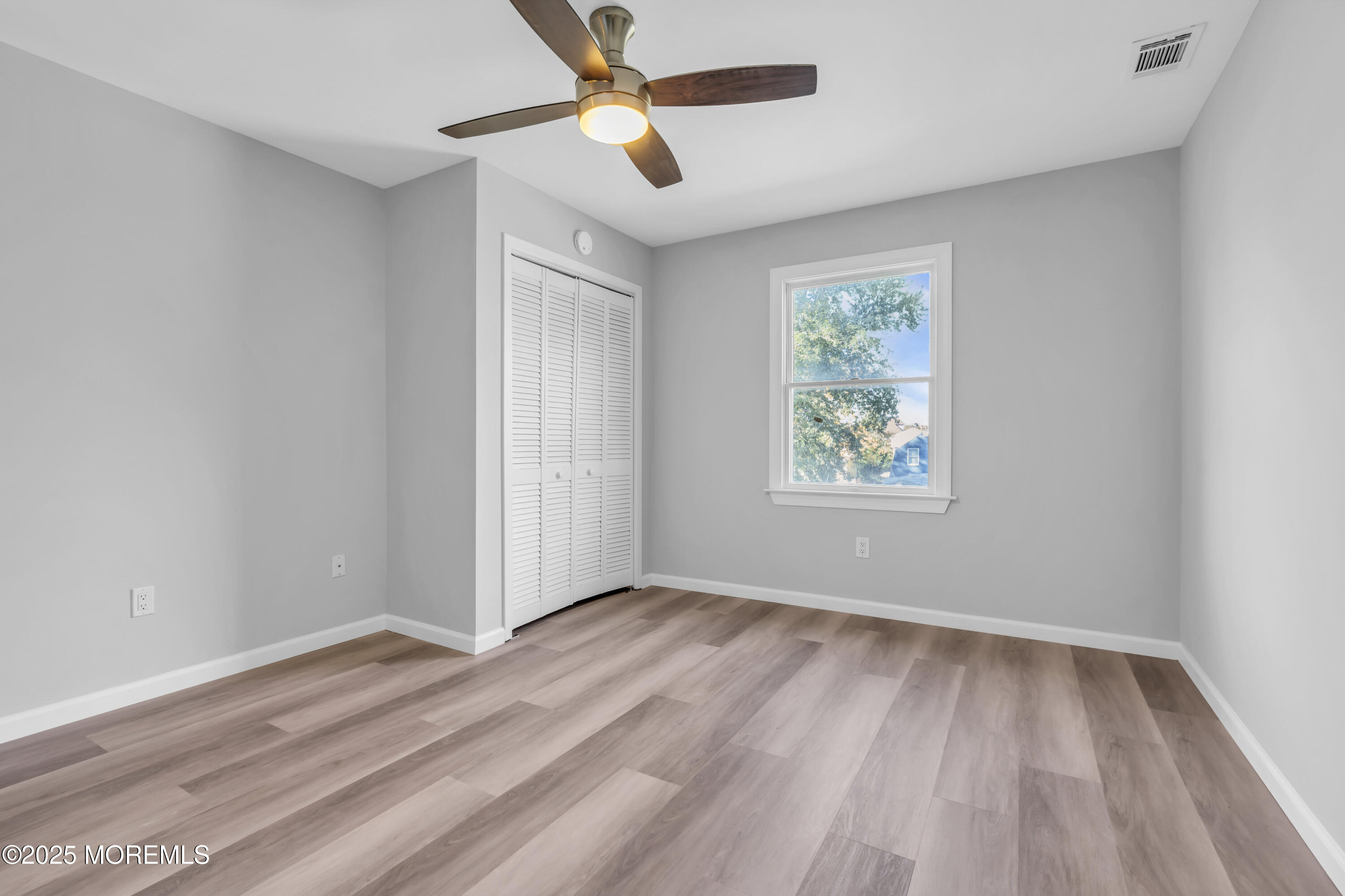 213 Main Street, Unit 17 Keansburg, NJ 07734 - Photo 15 of 15 wooden floor in an empty room with a window