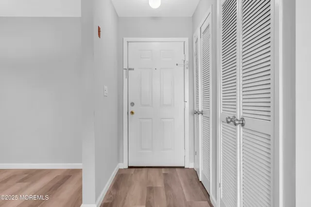 a view of a hallway with wooden floor