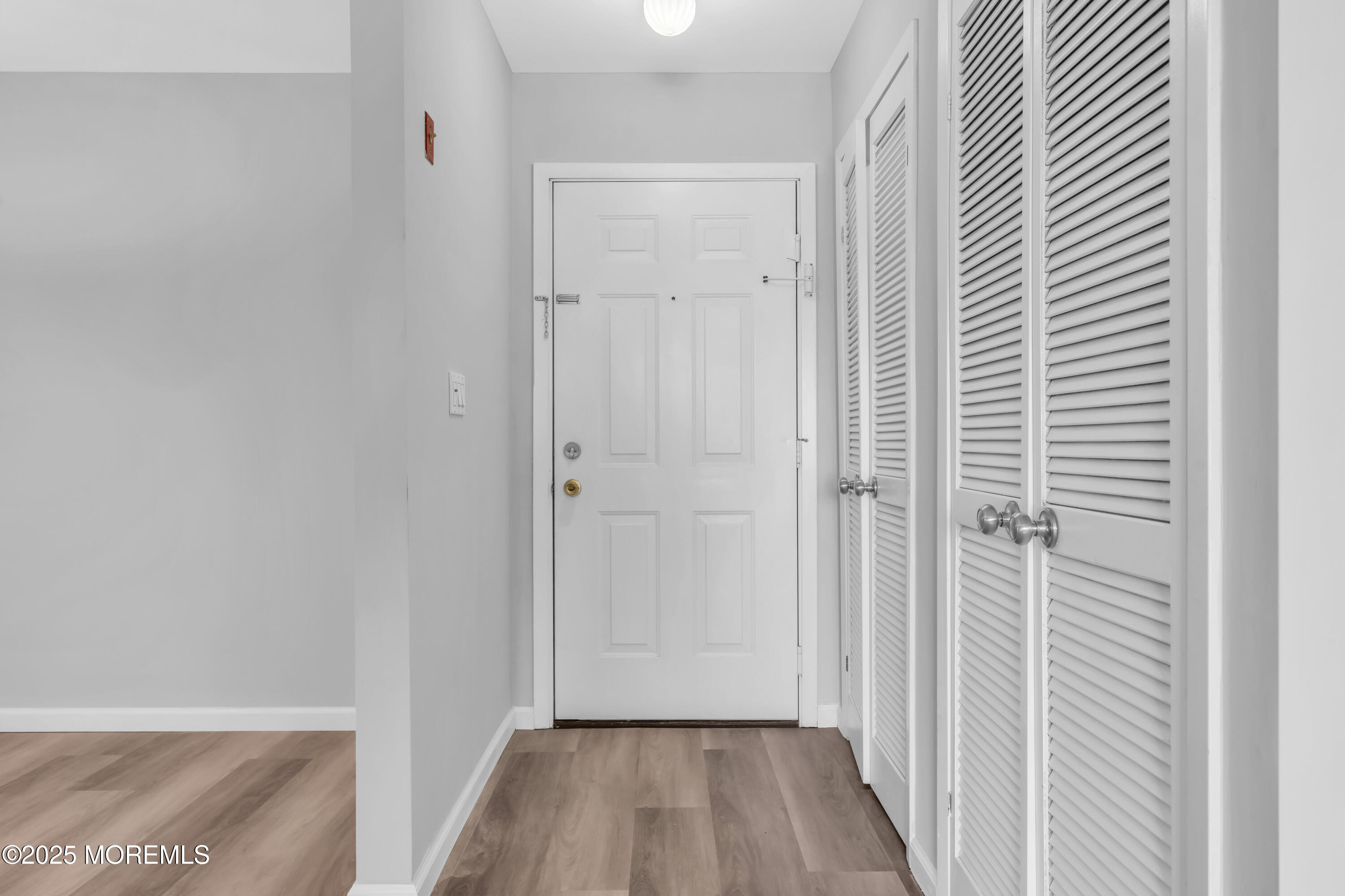 213 Main Street, Unit 17 Keansburg, NJ 07734 - Photo 2 of 15 a view of a hallway with wooden floor