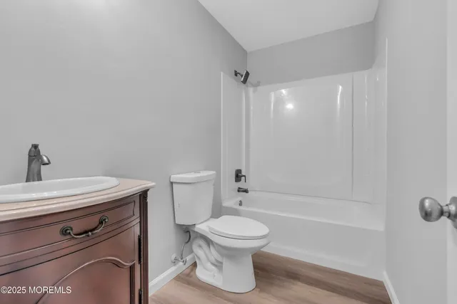 a bathroom with a toilet a sink and bathtub