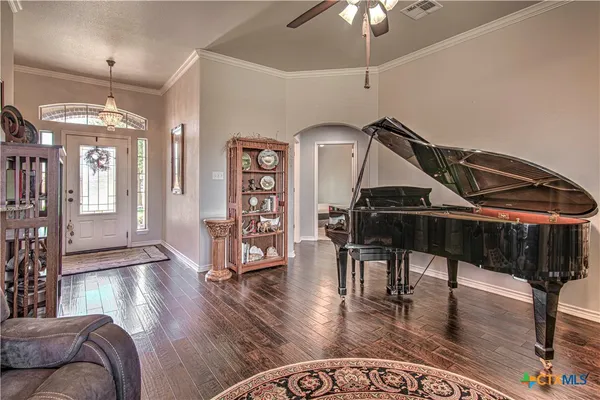 a living room with furniture and wooden floor