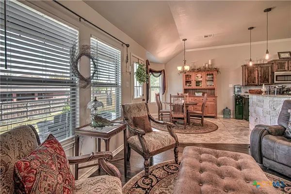 a living room with furniture and a chandelier