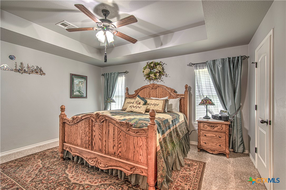 412 Dandridge Drive Temple, TX 76502 - Photo 21 of 44 a bedroom with a bed and a chandelier